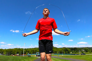 general picture of a male athlete jumping rope during daytime